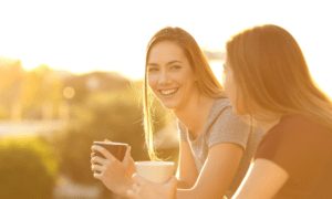 Happy woman sitting and enjoying conversation