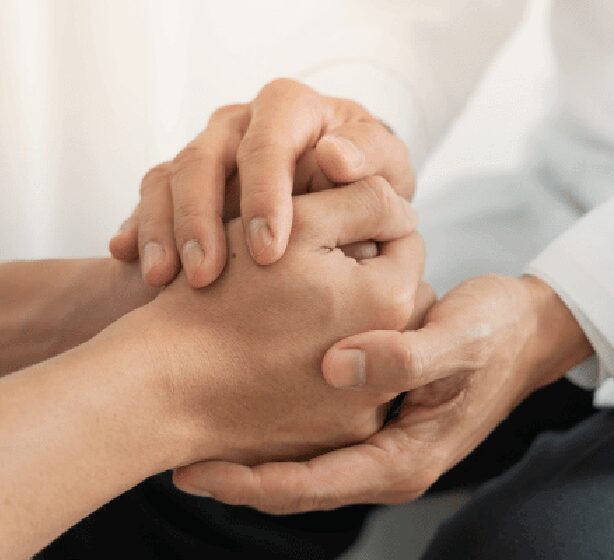 A psychiatrist holds a patients' hands portraying support of patient admission for medical detox treatment