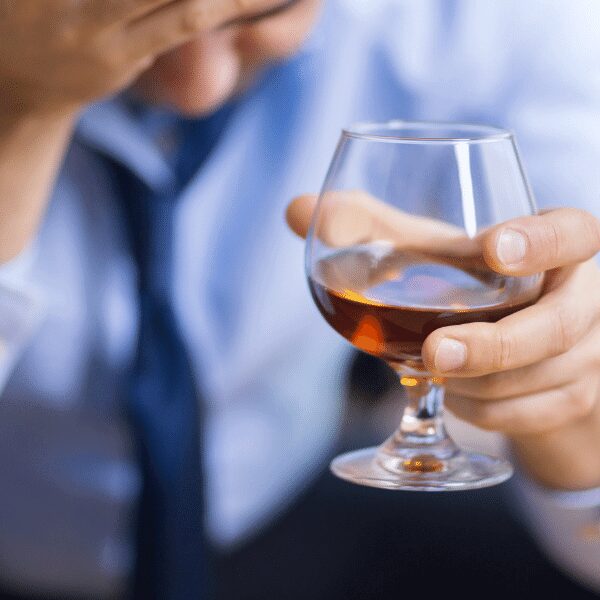 Airline staff man holding a glass of alcohol after overindulging