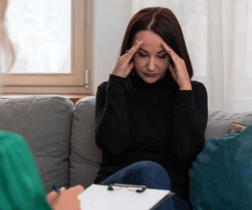 A distressed woman meeting with a therapist about medication-assisted treatment for alcohol abuse