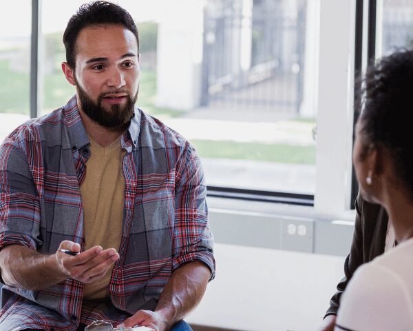 A therapist for a meth addiction rehab program talking during group therapy