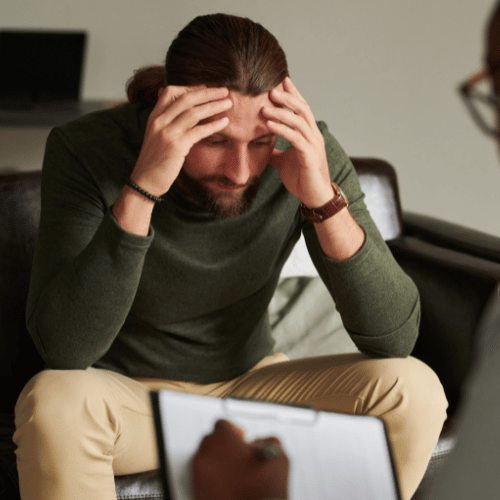 A man in distress while discussing benzo addiction treatment with a therapist