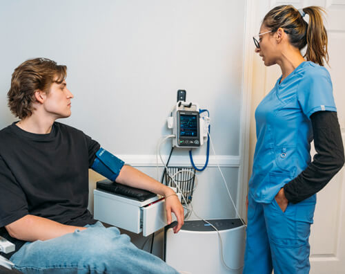 A medical professional checks a drug and alcohol detox patient's blood pressure