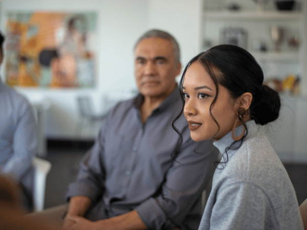 A young woman and a senior man in cocaine addiction group therapy