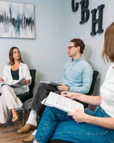 Group therapy for mental health and substance addiction at a behavioral health treatment facility