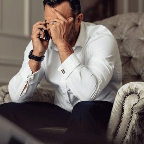 Businessman making a confidential call to a substance use disorder hotline